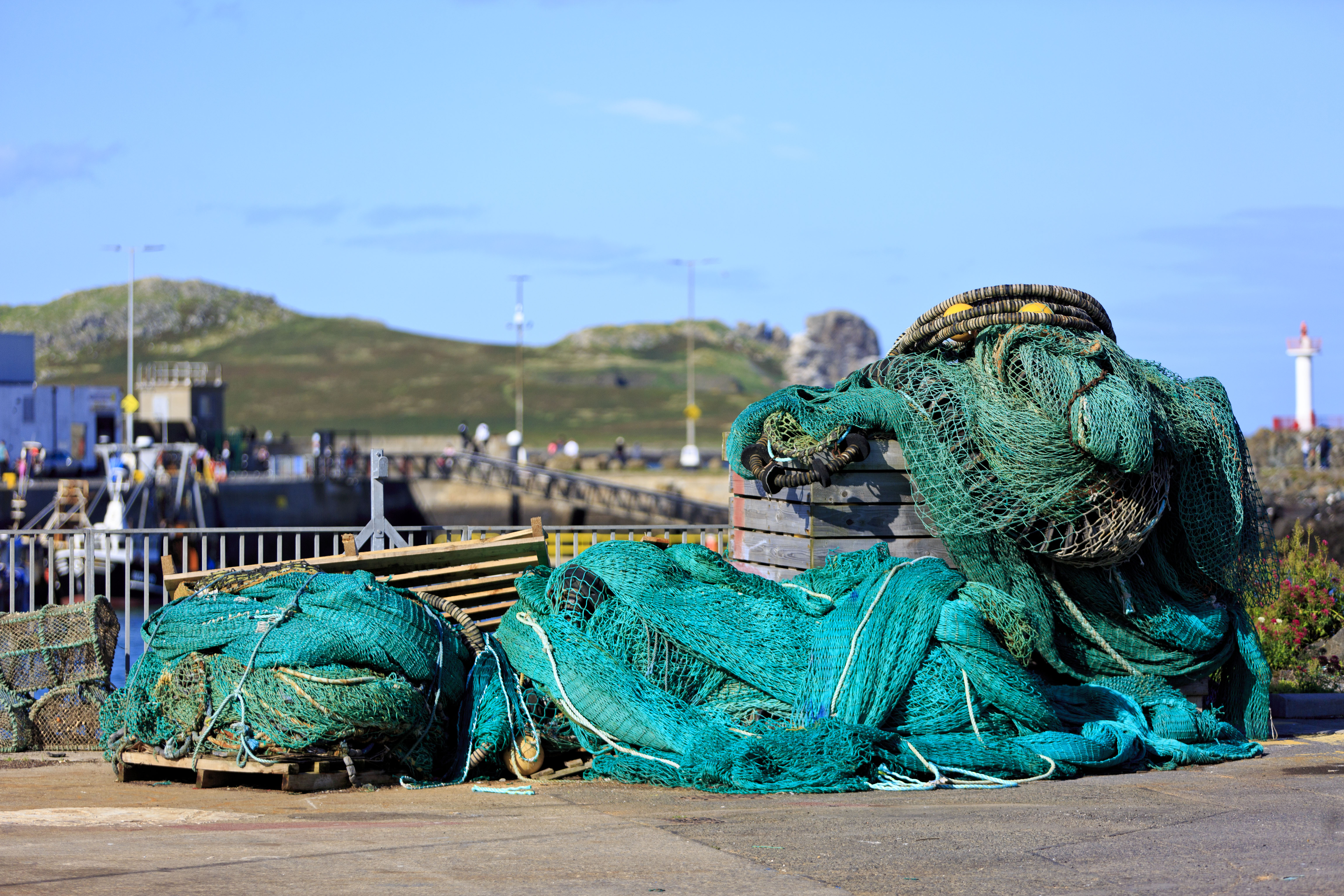 fishing gear and nets in pile on pier